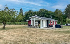 A single-story house with a covered porch, a barbecue grill, and a satellite dish. - Lovely home in Storvorde with WiFi (Storvorde)