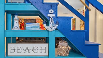 Eine blaue Treppe mit einem Schild, auf dem 'BEACH' steht, und einem dekorativen Anker.