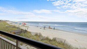 A beach with a wooden walkway leading to the shore, a sandy beach, and the ocean. - 3 Bedroom Oceanfront: Stargazing from the 2nd Flr (Pawleys Island)