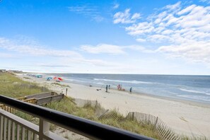 A beach with a wooden walkway leading to the shore, a sandy beach, and the ocean. - 3 Bedroom Oceanfront: Stargazing from the 2nd Flr (Pawleys Island)
