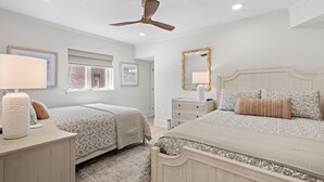 A bedroom with two beds, a ceiling fan, a window, and a dresser. - 3 Bedroom Oceanfront: Stargazing from the 2nd Flr (Pawleys Island)