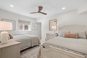A bedroom with two beds, a ceiling fan, a window, and a dresser. - 3 Bedroom Oceanfront: Stargazing from the 2nd Flr (Pawleys Island)