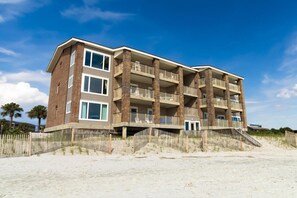 A multi-story hotel with balconies, located near a sandy beach. - 3 Bedroom Oceanfront: Stargazing from the 2nd Flr (Pawleys Island)