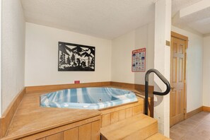 A spa room with a wooden tub, a poster, and a sign listing spa rules. - Ski In/Out | A/C in Summer | Fresh Renovation 2026 (Steamboat Springs)
