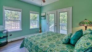A bedroom with a bed, a ceiling fan, a window, and a door. - 3-bedroom 2-bathroom house centrally located Camden side of Lake Wateree! (Camden)