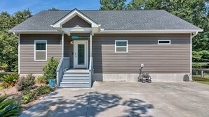A two-story house with a front porch, a garage, and a driveway. - 3-bedroom 2-bathroom house centrally located Camden side of Lake Wateree! (Camden)
