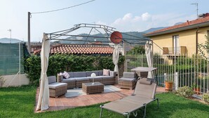 A patio with outdoor furniture, a pergola, and a view of the surrounding landscape. - ‘Elegant Lake Iseo’ Apartment with Lake & Mountain Views, Wi-Fi, Air Conditioning (Paratico)