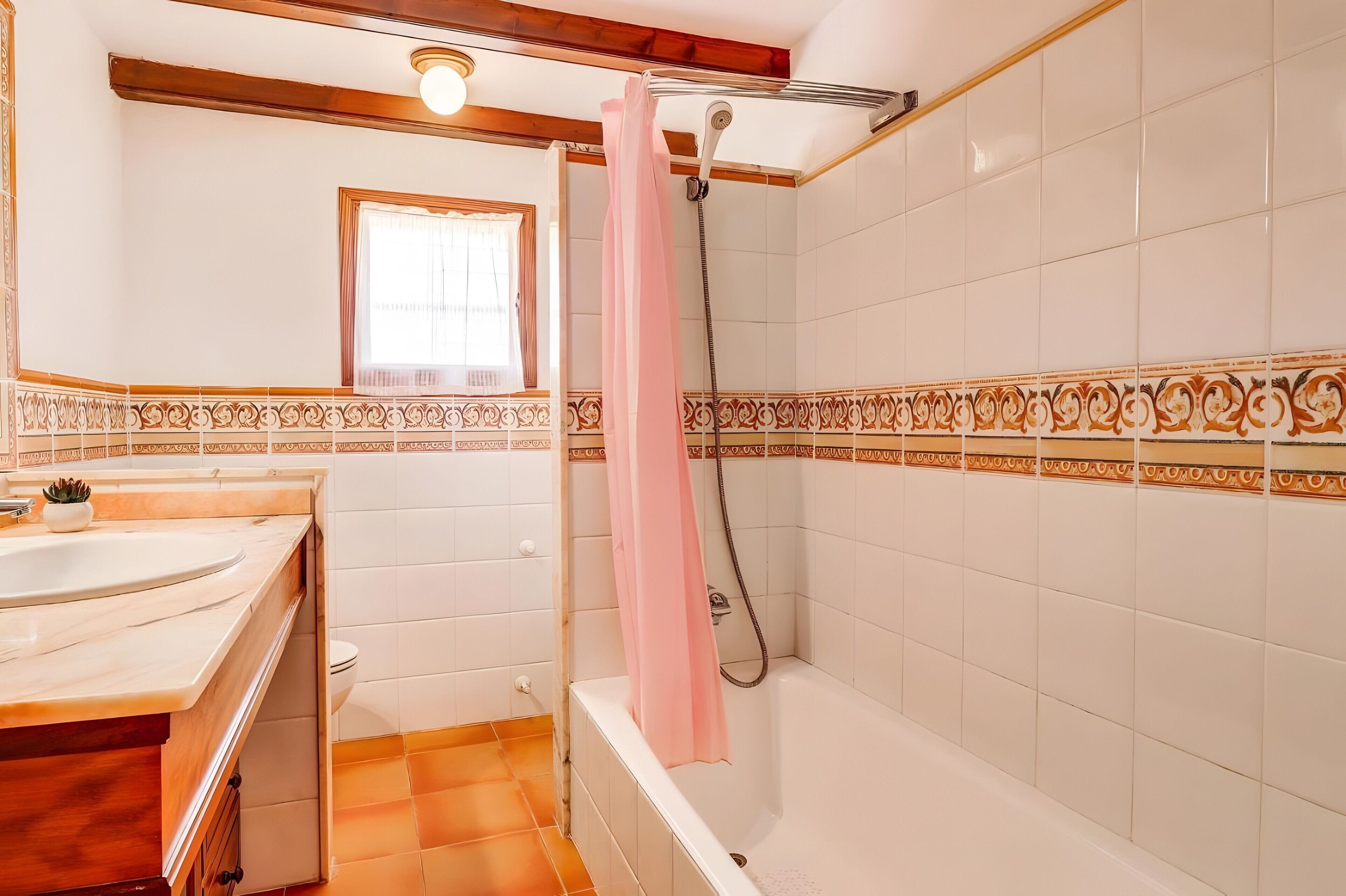 A bathroom with a bathtub, a shower, and a sink.