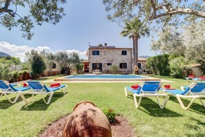 A stone villa with a swimming pool, lounge chairs, and a view of the surrounding landscape. - Villa 'Can Joan' with Mountain View, Wi-Fi and Air Conditioning (Pollença)