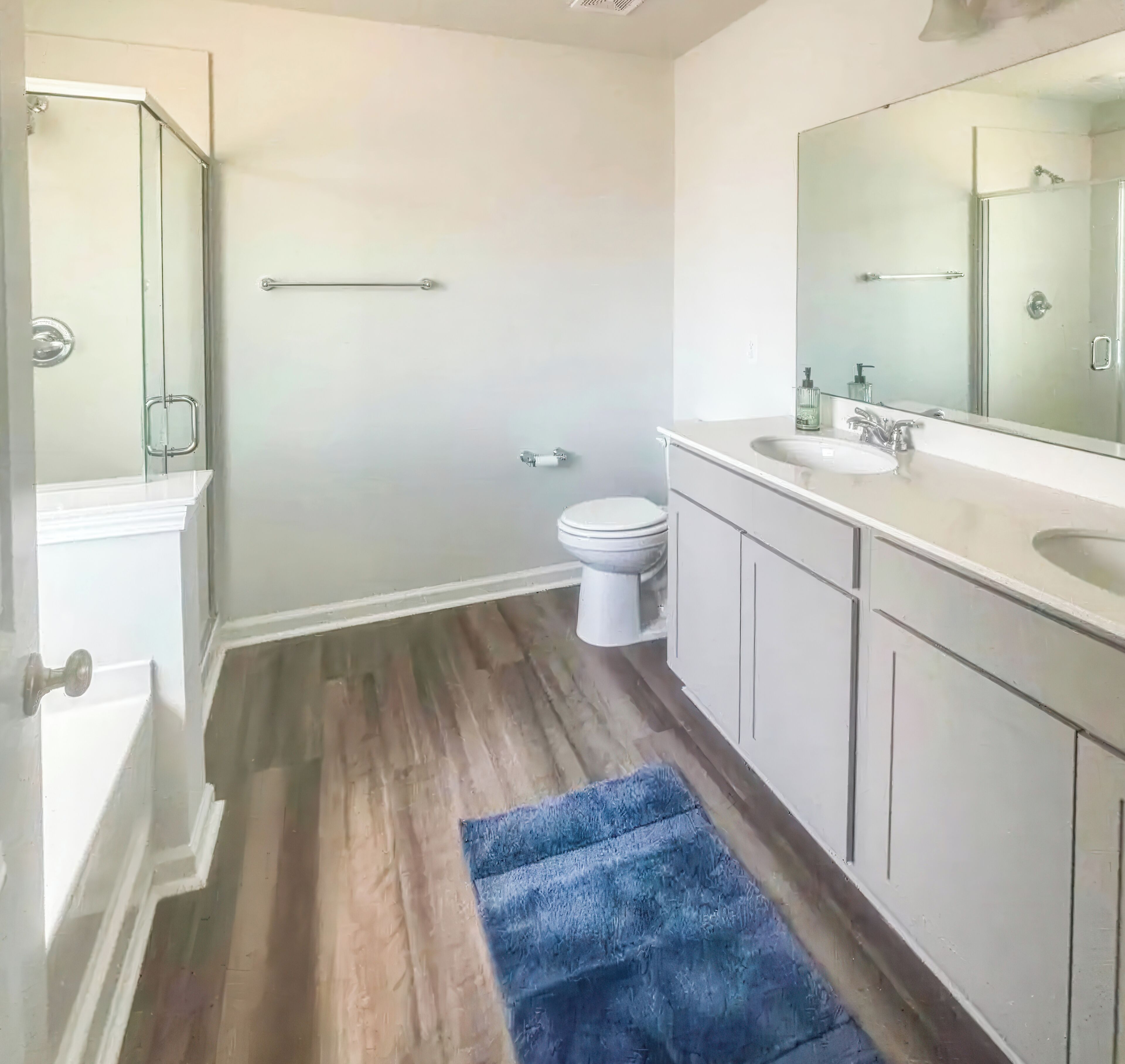 A bathroom with a shower, toilet, and sink.