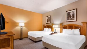 A hotel room with two beds, a desk, and a television. - Spacious 3BR/3BA with Jacuzzi, Fireplaces & FREE Waterpark Passes! (Wisconsin Dells)