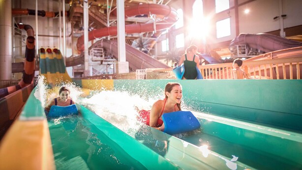 An indoor water park with slides and a pool area. - Spacious 3BR/3BA with Jacuzzi, Fireplaces & FREE Waterpark Passes! (Wisconsin Dells)