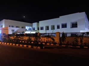A modern two-story building with a white facade, multiple windows, and a gated entrance. - Stratton 38 Hotel Asokoro (Abuja)