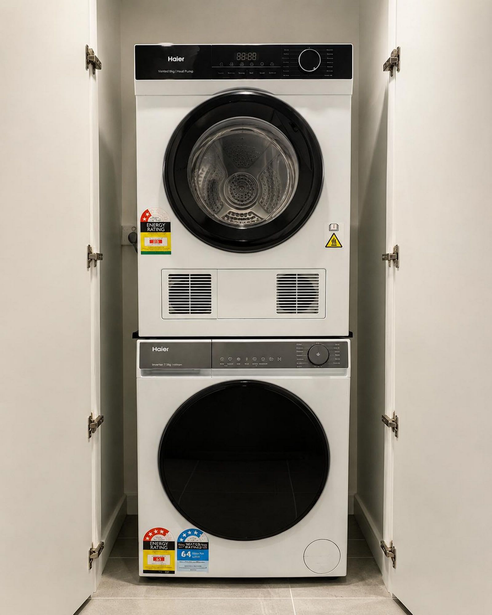 A compact, wall-mounted Haier washer and dryer unit with energy and water efficiency ratings.