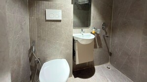 Un baño moderno con inodoro, lavabo y ducha.