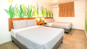 A hotel room with two beds, a wall mural, a window with curtains, and a ceiling light fixture.