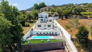 A multi-story building with a swimming pool and outdoor seating area. - Olival Dream House - Boutique House w/ Pool (Pedorido)