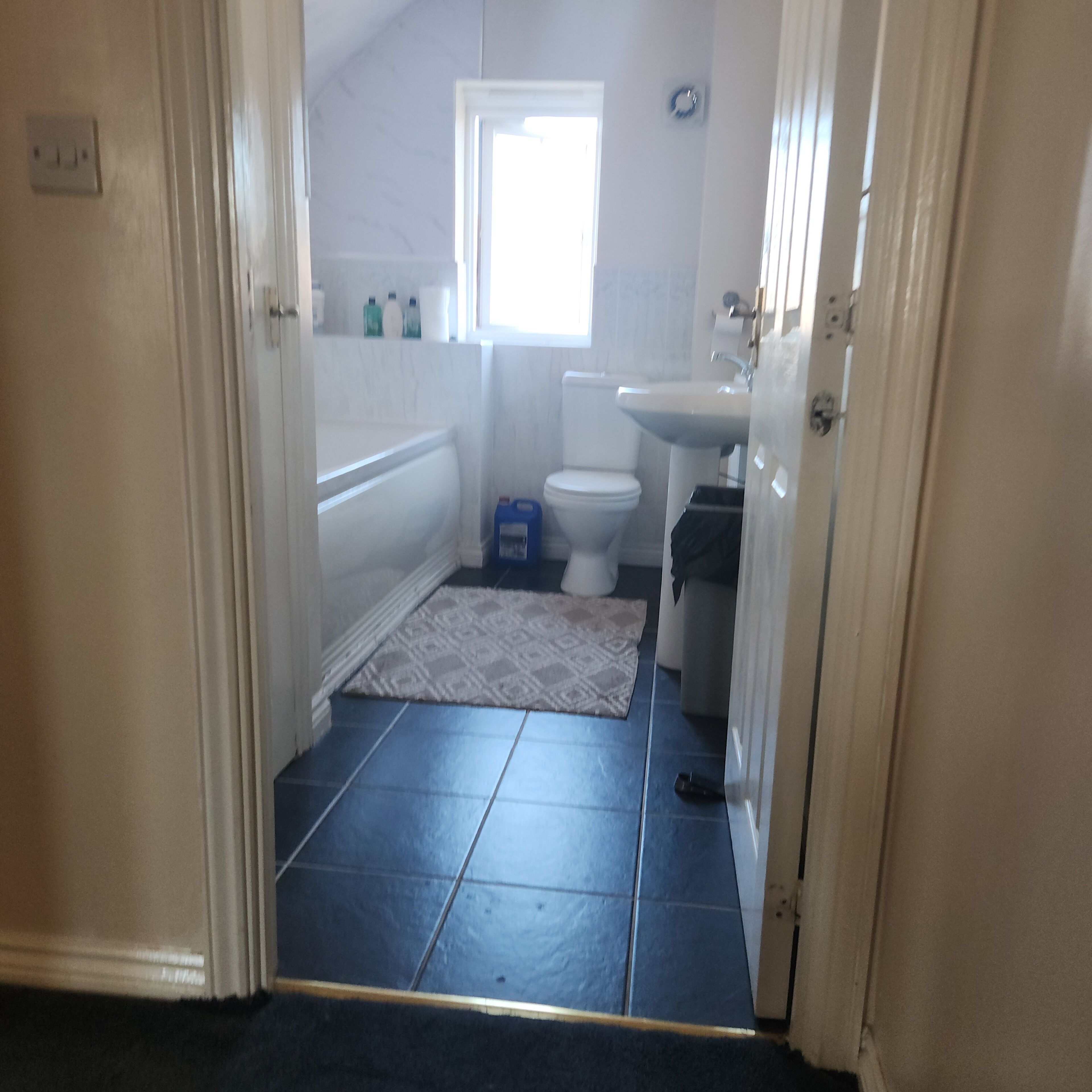A bathroom with a bathtub, toilet, and sink.