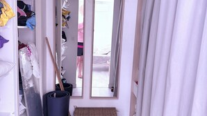 A narrow hallway with a wardrobe, a mirror, a trash bin, and a woven basket. - Large family home with spacious, landscaped terraces, 100 meters from the beach (Mauguio)