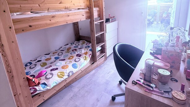 A bunk bed with a colorful mattress, a desk with various items, and a window with a view of the outdoors. - Large family home with spacious, landscaped terraces, 100 meters from the beach (Mauguio)
