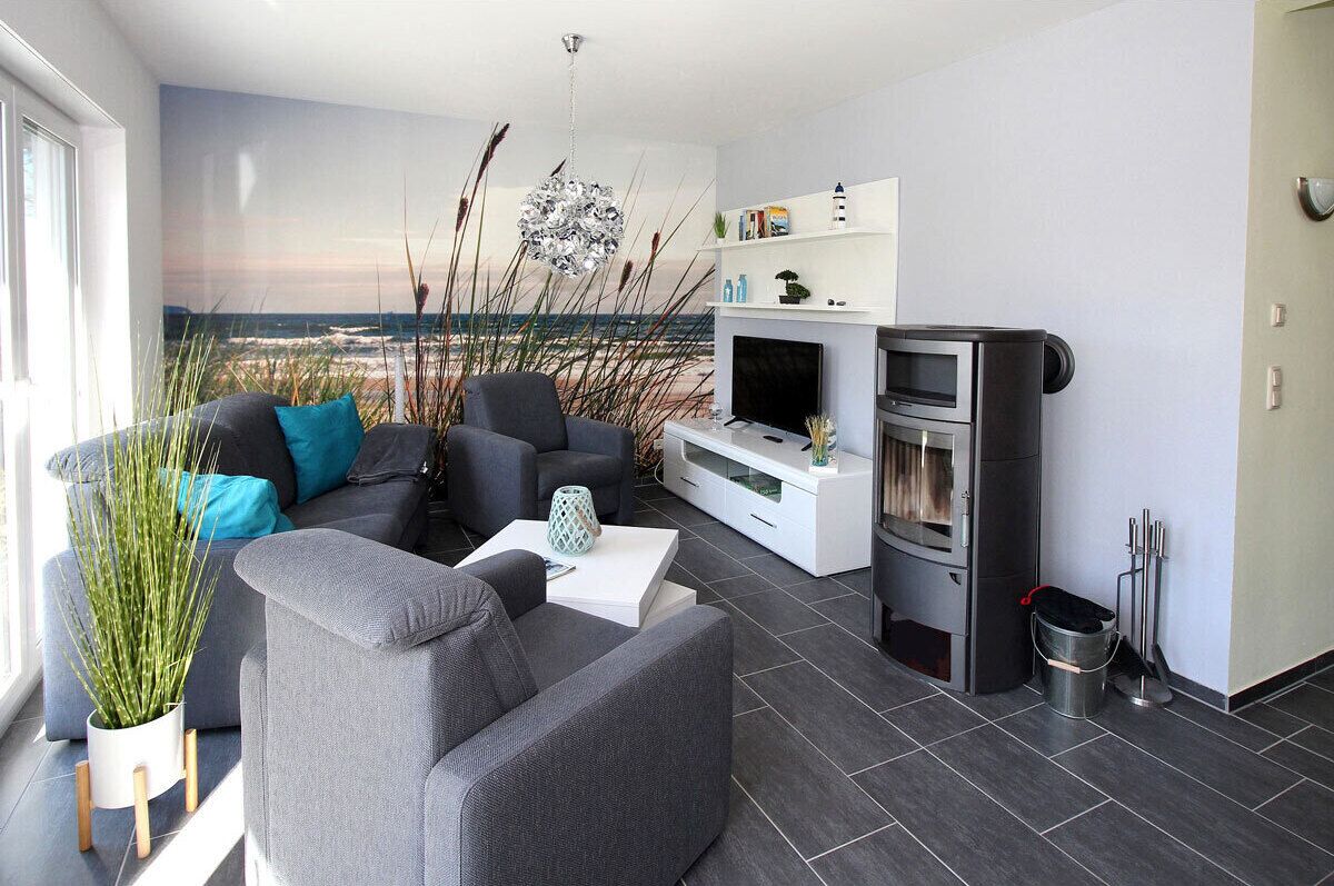 A modern living room with a sofa, coffee table, and a flat-screen TV.