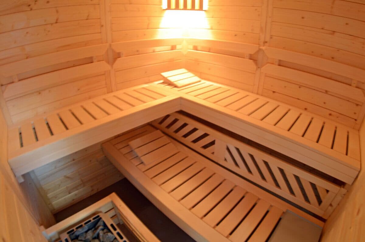 A wooden interior with slatted ceilings and a central light fixture.