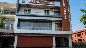 A multi-story building with a sign for 'PRINCE HOTEL & RESTAURANT' on the upper floor. - Prince Hotel (Meerut)