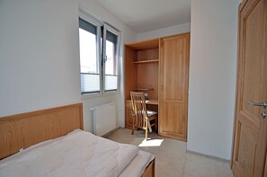 A bedroom with a bed, a chair, a desk, and a wardrobe. - 2-story vacation home, quiet location, about 1.3 kilometers from the sandy beach, Wi-Fi (Glowe)