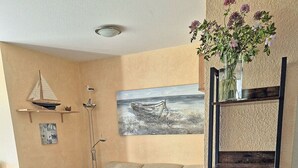 A living room with a sofa, armchairs, a coffee table, a side table, and a bookshelf. - Vacation rental, very quiet location, about 350 m from the sandy beach (Baltic Sea), Wi-Fi (Glowe)