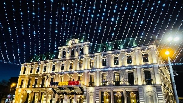 A historic building with a grand entrance, multiple windows, and a well-lit facade. - Grand Hotel Traian (Iași)
