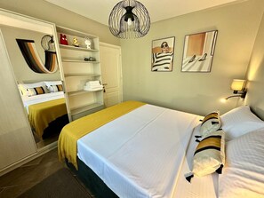 A bedroom with a bed, a wardrobe, a mirror, and a wall-mounted fan. - Art-Villa SeLena (Šušanj)