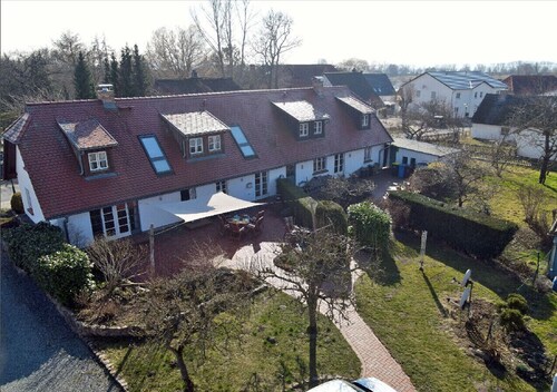 Spanning 2 floors on the Bodden, with a terrace featuring patio furniture, a washing machine, and internet access