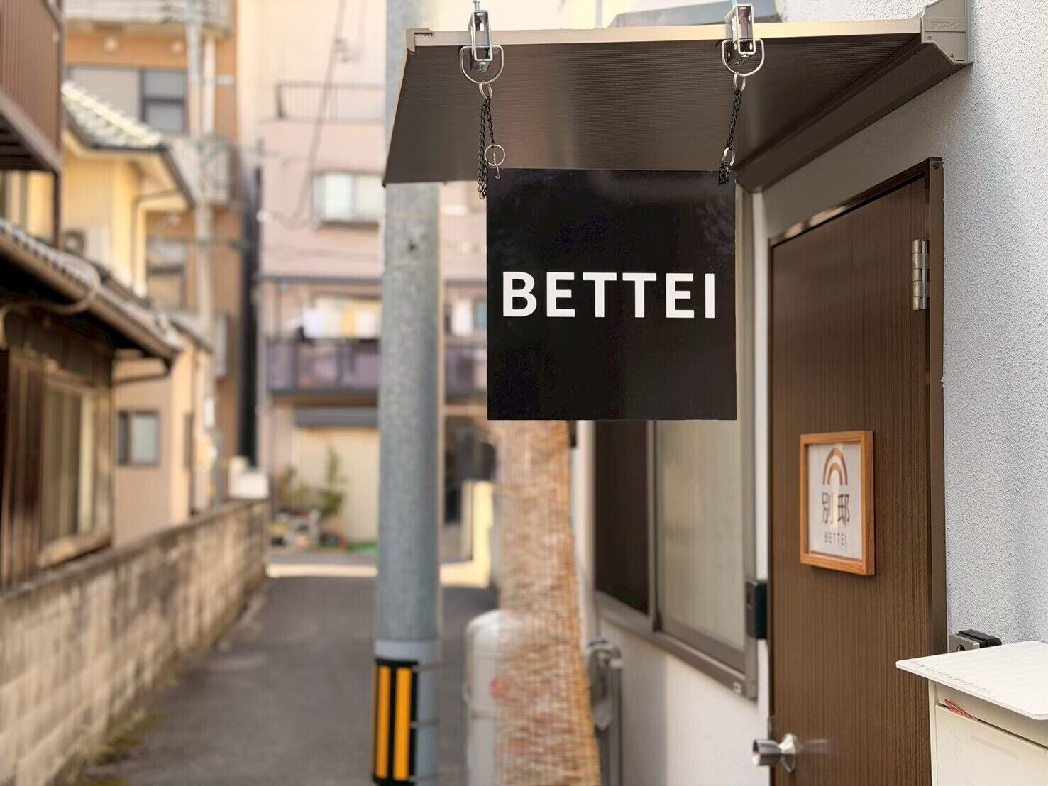Une enseigne avec le mot « BETTEI » est suspendue à un bâtiment.