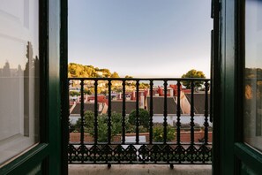 A balcony with a view of a cityscape, including buildings and trees. - Hacienda Clavero Five Deluxe Apartment: (Málaga)