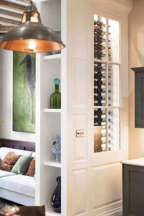 A room with a wine rack, a painting, and a lamp. - Preacher's Yard Stylish Central York Apartment - Duplex 4 (York)