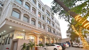 A hotel with a classic architectural style, featuring a prominent entrance with a staircase, multiple windows, and a visible brand name. - TrimHotel Grandview Jaipur (Jaipur)