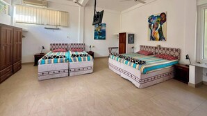 A bedroom with two beds, a wardrobe, a desk, and a ceiling fan. - The Hilltop Boosa (Boossa)