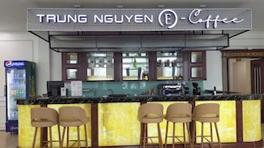 A coffee bar with a neon sign, a Pepsi refrigerator, and bar stools. - White Palace Quynh Coi (Quynh Phu)