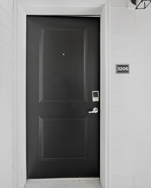 A black door with a keypad lock and a doorbell. - Comfortable 2BR Retreat (Princeton)