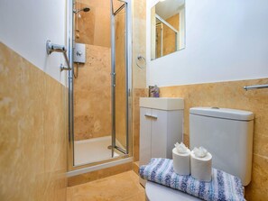 A bathroom with a glass-enclosed shower, a white sink, and a toilet. - Waterfront Stay for Two (Whitby)