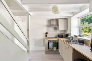 A modern kitchen with a built-in oven, a microwave, and a kettle. - #161 Stylish Bodmin Cornwall Stay - Sleeps 6 (Cornwall)