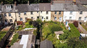 A residential area with terraced houses, a fenced garden, and a clothesline.