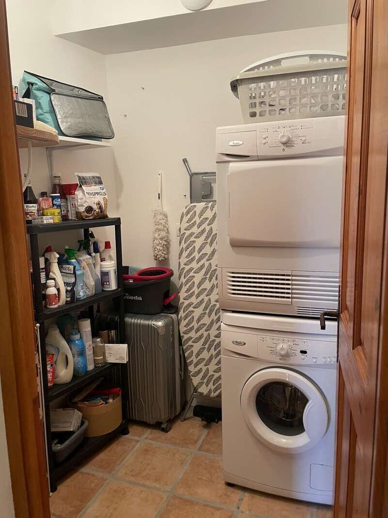 A laundry area with a washing machine, a dryer, and a shelf with cleaning supplies.