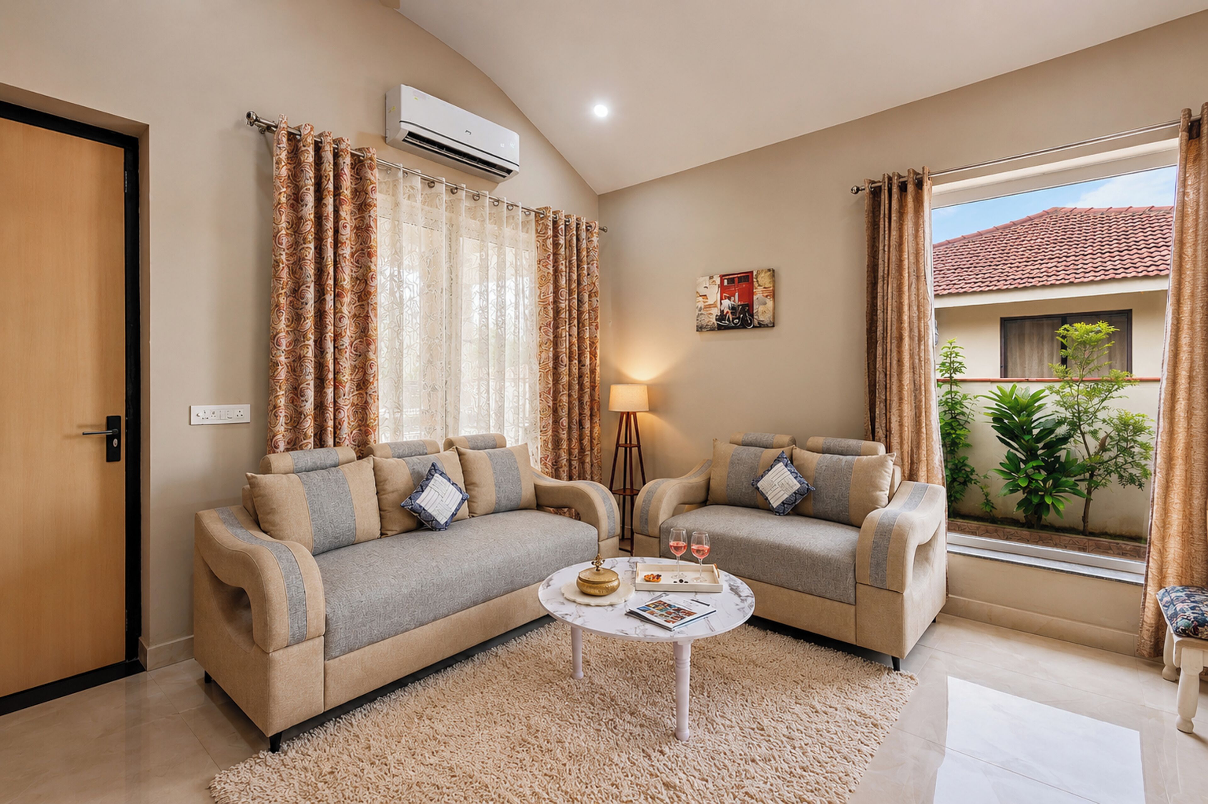 A living room with two sofas, a coffee table, and a window with curtains.