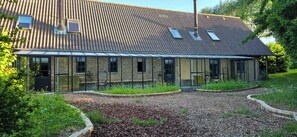 A modern building with a glass conservatory, brick walls, and a sloped roof. - Views across the fields to the sea on Langeland (Tranekær)