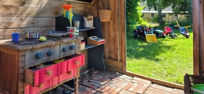 A rustic outdoor kitchen with a wooden stove, various cooking utensils, and a small sink. - Views across the fields to the sea on Langeland (Tranekær)