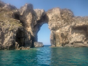 A natural rock formation with a clear water channel.