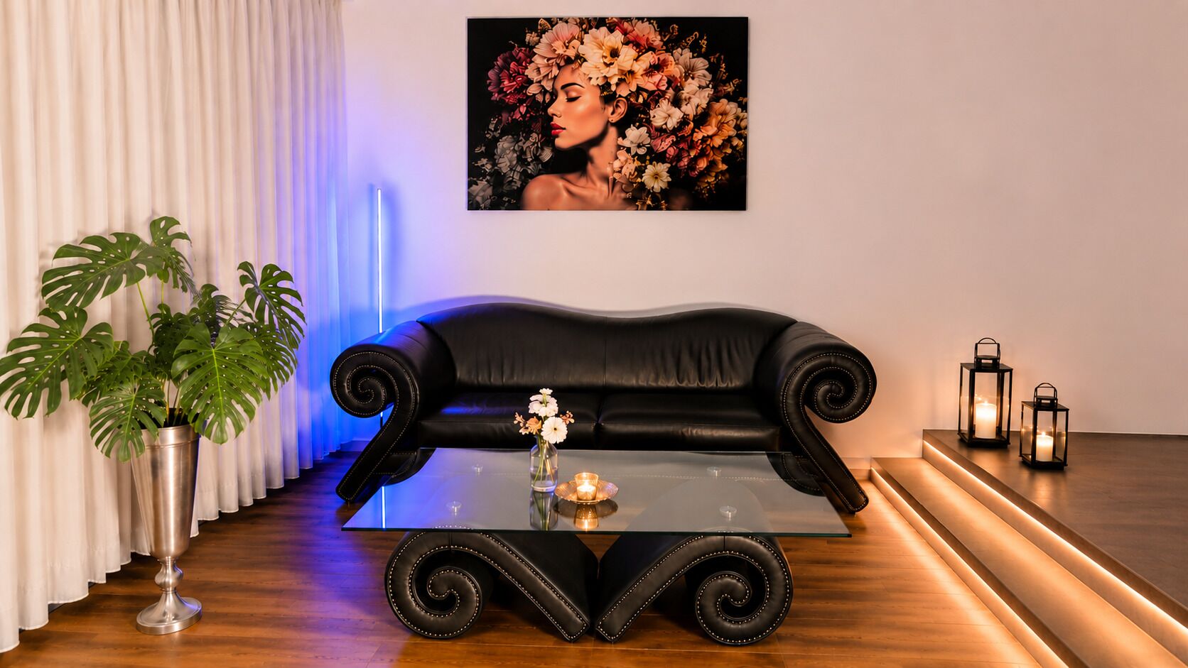 A black leather sofa with a glass coffee table, a potted plant, and a framed artwork on the wall.