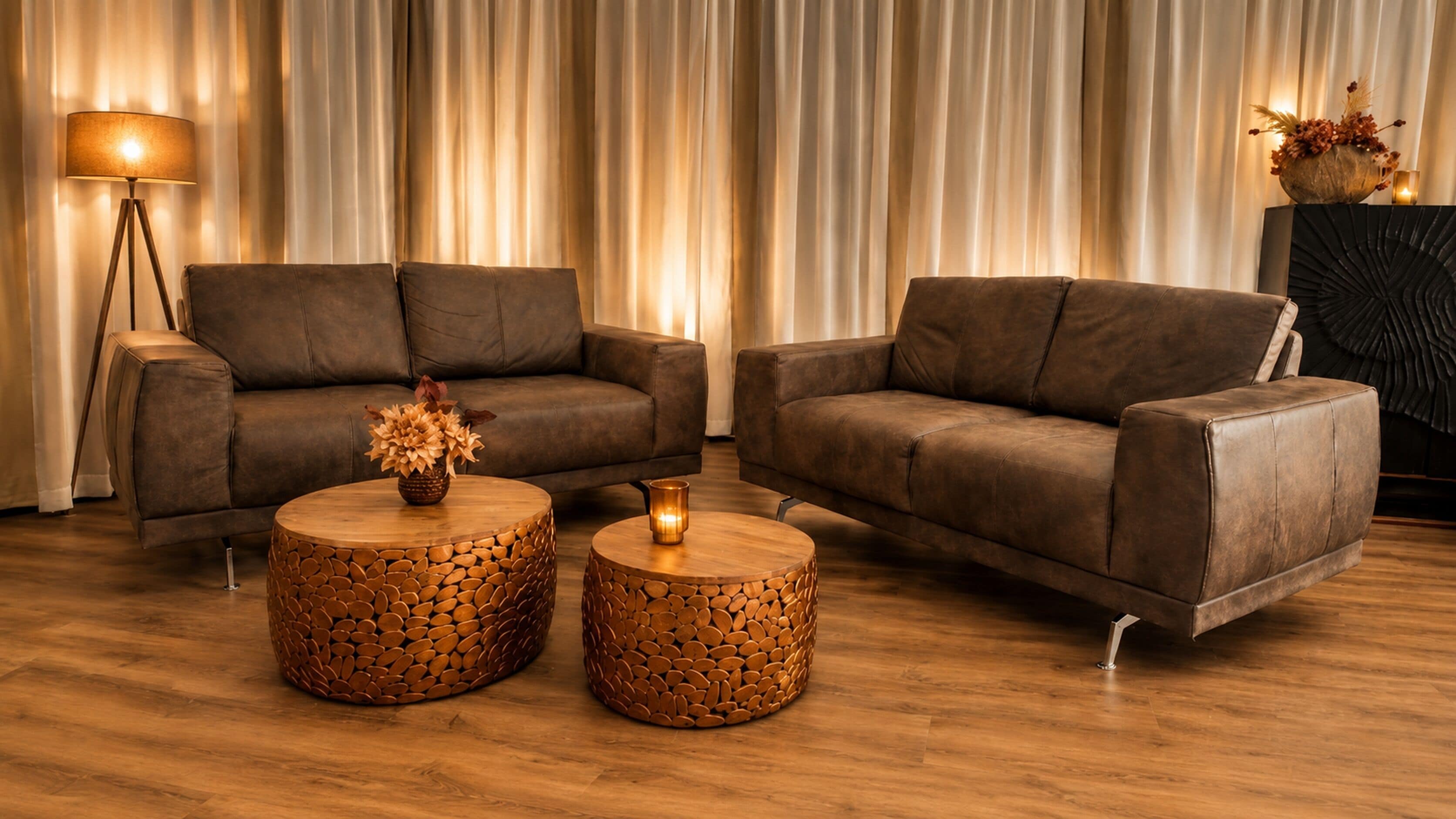 Ein modernes Wohnzimmer mit zwei Sofas, einem Couchtisch und einer Stehlampe.