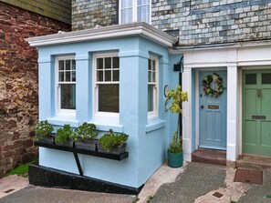 A blue house with a small porch, a green door, and a wreath on the door. - Holiday Stay With Sea Glimpse (Torpoint)